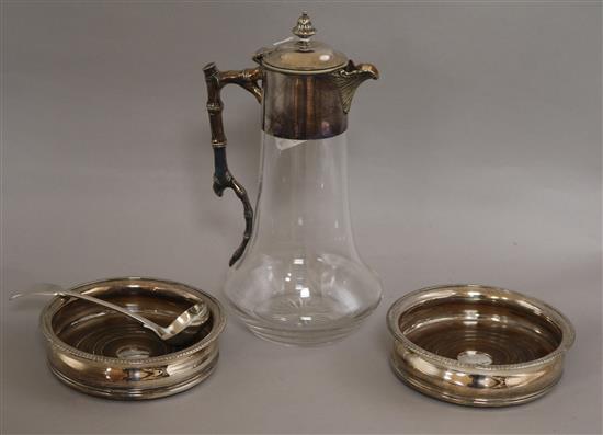 A silver plate mounted claret jug, a pair of silver plated wine coasters and a plated sauce ladle.
